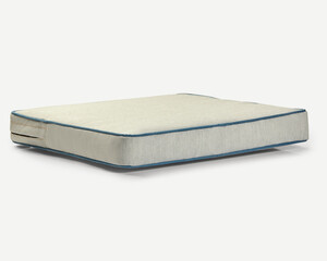Comfortable mattress pad with blue piping detailing resting on white background