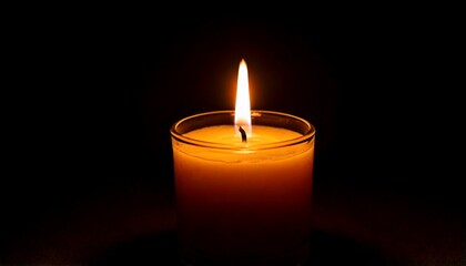 One candle burning slowly isolated on pitch black background