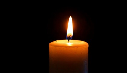 One candle burning slowly isolated on pitch black background