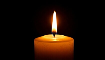 One candle burning slowly isolated on pitch black background