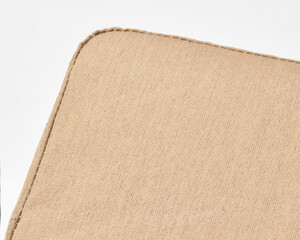 Close-up of beige linen upholstery showing stitching detail