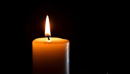 One candle burning slowly isolated on pitch black background