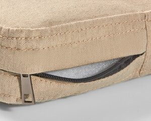Open zipper showing foam filling of beige fabric cushion