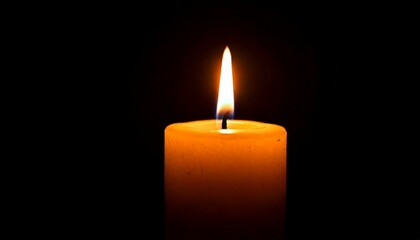 One candle burning slowly isolated on pitch black background