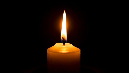 One candle burning slowly isolated on pitch black background