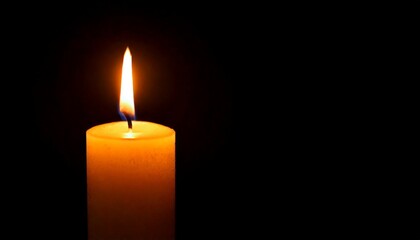 One candle burning slowly isolated on pitch black background