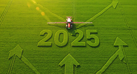 Obraz premium Aerial View of 2025 Tractor Spraying Vibrant Green Field