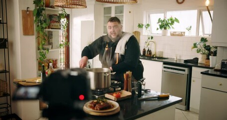 Camera, cooking and man in kitchen with food, dinner or recipe online with content creation. Meal, recording and male chef influencer with equipment for live streaming with diet advice in home.