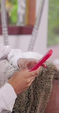 a close up of a woman with red nails texting on their phone with a matching red case