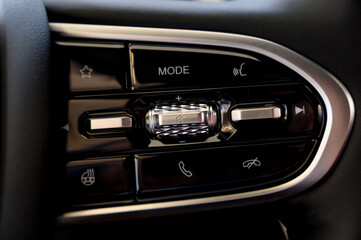 Obraz premium A close-up of a modern car's steering wheel with control buttons