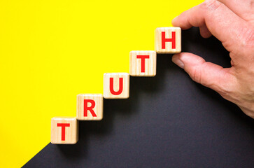 Truth symbol. Concept word Truth on beautiful wooden blocks. Beautiful yellow and black background....