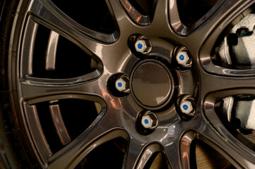 Car wheel with brake calipers and stylish design.