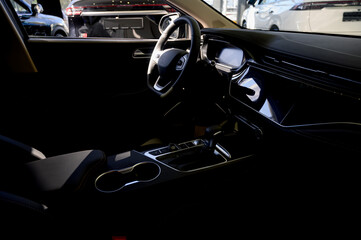 Fototapeta premium Close up of modern new car interior with black leather seats