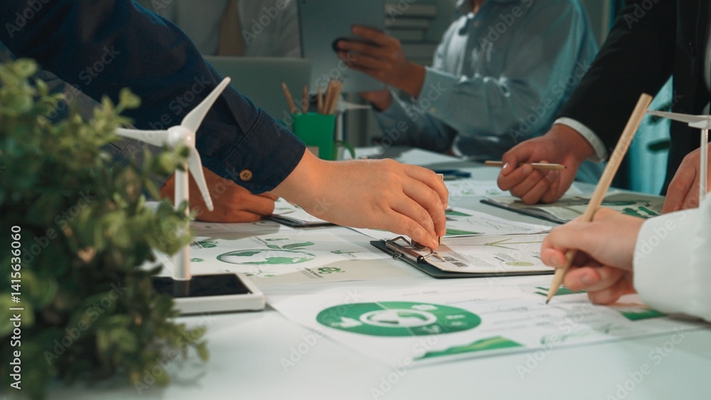 Poster a dynamic business meeting scene showcasing hands engaged in planning and analyzing sustainable deve