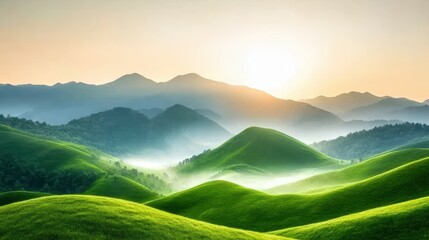 Fototapeta premium Green mountains during autumn, with mist rolling through the valleys in golden morning light.