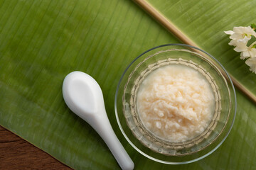 sweet fermented rice in glass bowl,a sweetmeat consisting of fermented glutinous rice,Traditional Thai food.(Kaomark).Top view copy space.