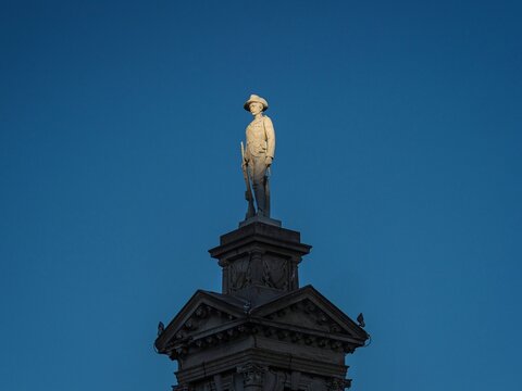 Soldier statue sculpture illuminated by the sun on top of Troopers South Africa Boer War Memorial in Invercargill Southland South Island New Zealand