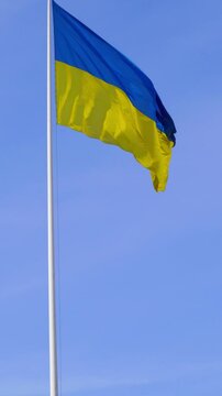 Bright Ukrainian flag in blue sky expressing cultural identity and selfhood