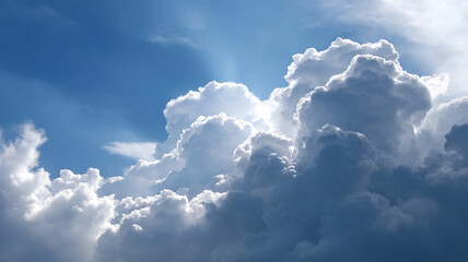 Fluffy white clouds rise majestically against vibrant blue sky, creating serene and awe inspiring cloudscape. Sunlight peeks through, highlighting cloud edges