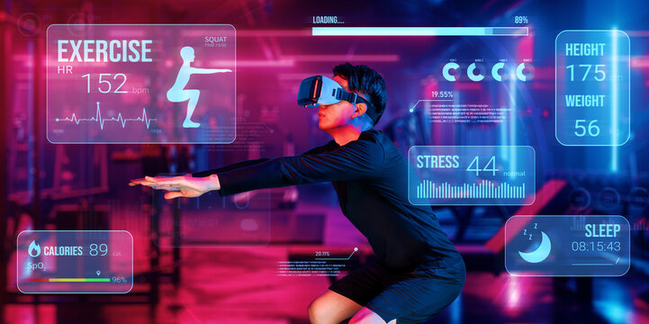 Happy asian man wearing VR glass while exercising at futuristic gym with glowing vibrant color. Male model using augmented reality technology for analysis data from holographic. Technology. Ingenuity.