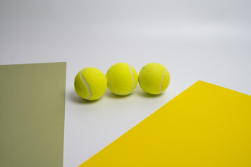 Yellow tennis balls on a colored background. Passing sports
