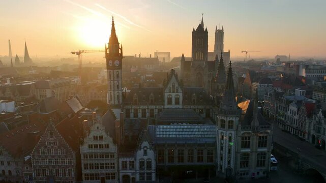 Belgian historic town of Ghent aerial view at sunrise, tourist destination in Belgium, drone shot of Belgian medieval town of Ghent with gothic cathedrals in the morning