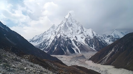 Fototapeta premium Snowy Mountain Peak in a Valley Landscape