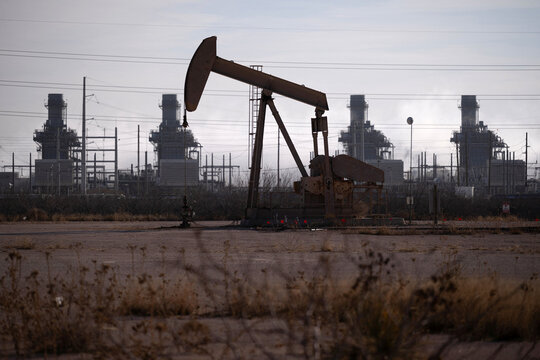 Pump Jack Near Gas Turbine Power Plant in Permian Basin Texas