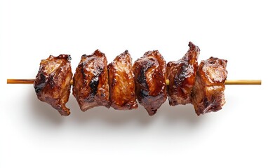 Overhead close-up of a yakitori skewer with six pieces of grilled meat, glazed with a dark brown sauce, on a solid white background