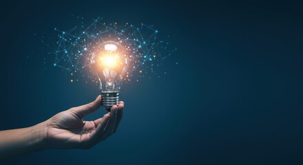 Hand holding glowing lightbulb with network connections on dark blue background.