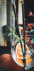 Summer cocktail with straws and orange slice wallpaper background