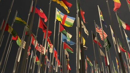 Flags of different countries are fluttering in the wind at the Flags Square in Doha in the evening - Powered by Adobe