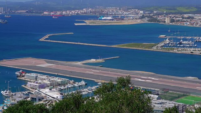 Boats resting in Alcaidesa Marina with city of La Linea de la Concepcion in the background