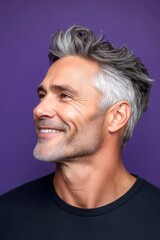 Fototapeta premium Classy men's undercut haircut - midlife white man with white hair. A chic and vibrant male with effortless elegance. Idea of style for aging men. Purple solid background.