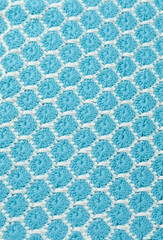 Crochet blanket with exquisite pattern, blue green white blanket and keychain knitting and white yarn on white background