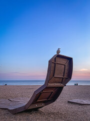 Seagull on the top of a metal construction on the beach in Brighton, England.