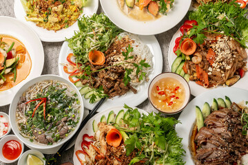 assortment of mixed traditional vietnamese food dishes on buffet table