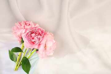Bouquet of delicate flowers peonies, roses on a sunny table for a gift to loved ones. Spring still life and banner for the screen, elegant beauty concept, template for design.