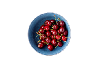 Cherries in blue ceramic bowl top view
