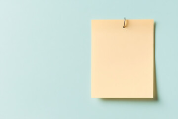 Blank Peach Note on Pastel Background. Space for text or design. Reminder concept. Light and minimalistic aesthetic.