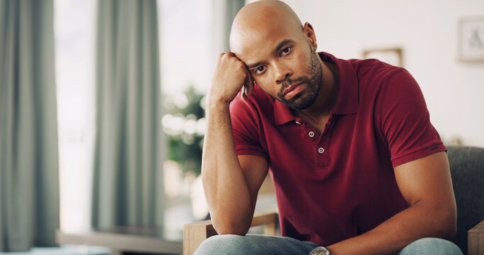 Bored, portrait and unhappy with man on sofa in living room of home for fail or mistake. Annoyed, body language and frustration with moody or sad person in apartment for attitude and depression