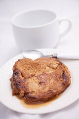 Toronjas - sweet wine-soaked bread with raisins, a traditional Easter Week dish from El Salvador on white tableware.