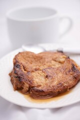 Toronjas - sweet wine-soaked bread with raisins, a traditional Easter Week dish from El Salvador on white tableware.