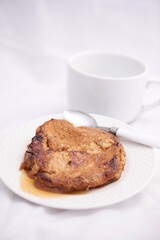 Toronjas - sweet wine-soaked bread with raisins, a traditional Easter Week dish from El Salvador on white tableware.