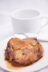 Toronjas - sweet wine-soaked bread with raisins, a traditional Easter Week dish from El Salvador on white tableware.