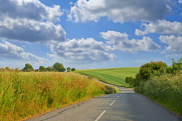 Landscape, road and clouds with field in countryside for travel adventure, sustainability and...