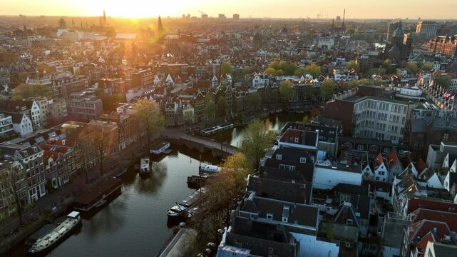 Amsterdam aerial view at sunset, drone shot of the capital of the Netherlands in spring, travel in Netherlands, old town of Amsterdam