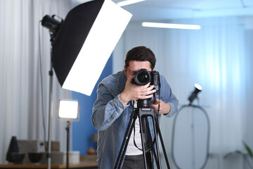 Man with professional video camera in studio