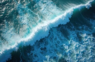 Aerial shot of seething ocean waves with foamy splash. Blue sea texture, open water. Ocean water surface with water pattern. Ideal for travel theme, vacation, summer, marine eco-concept.