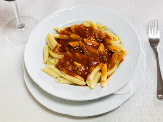 Traditional Italian dish - pasta bolognese. Meal consists of pasta and thick sauce, cooked ground beef, fried vegetables, red wine and spices. Aromatic hot dish.